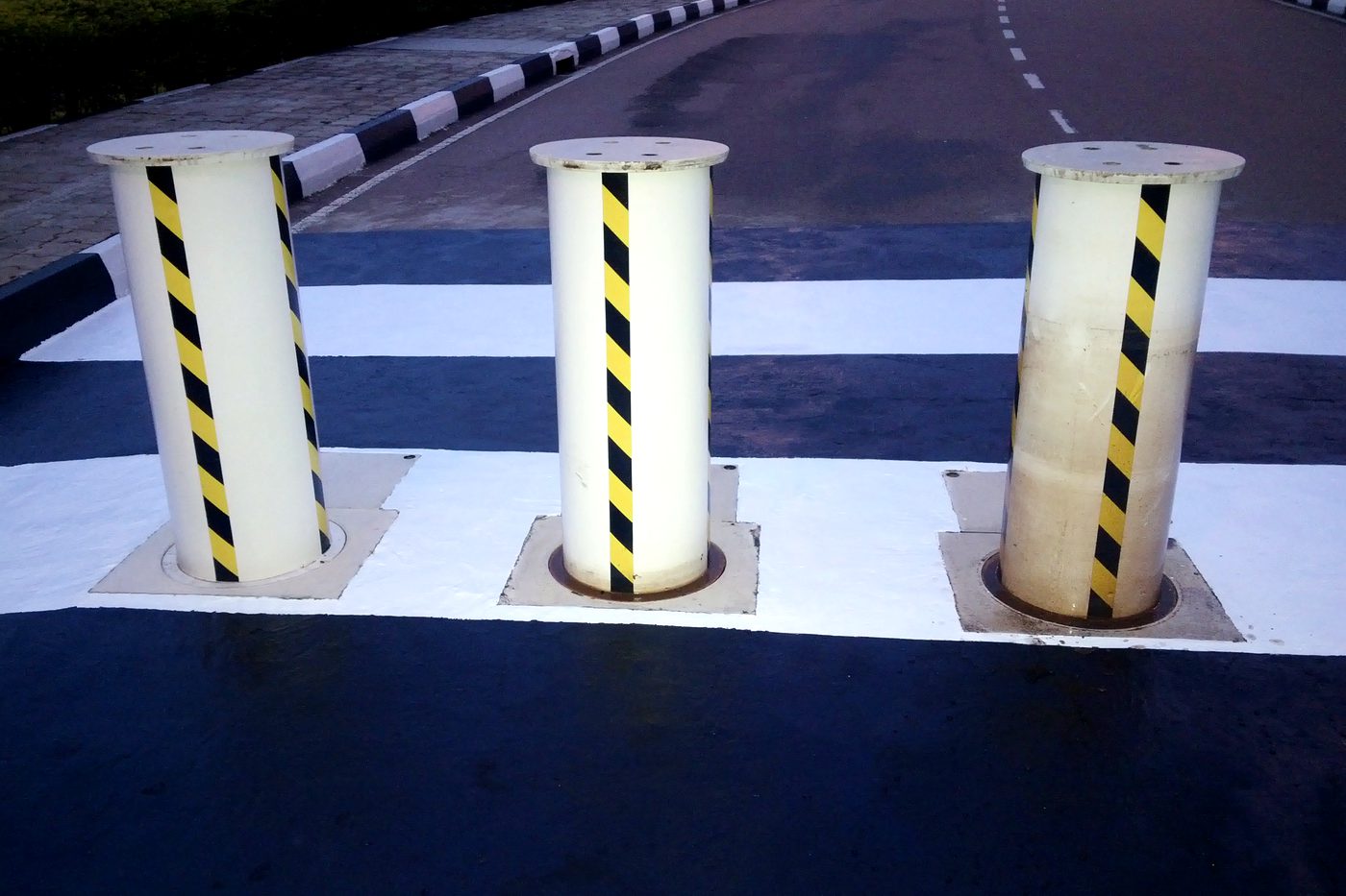 Automated retractable bollards installed by HMT at a controlled vehicle crossing